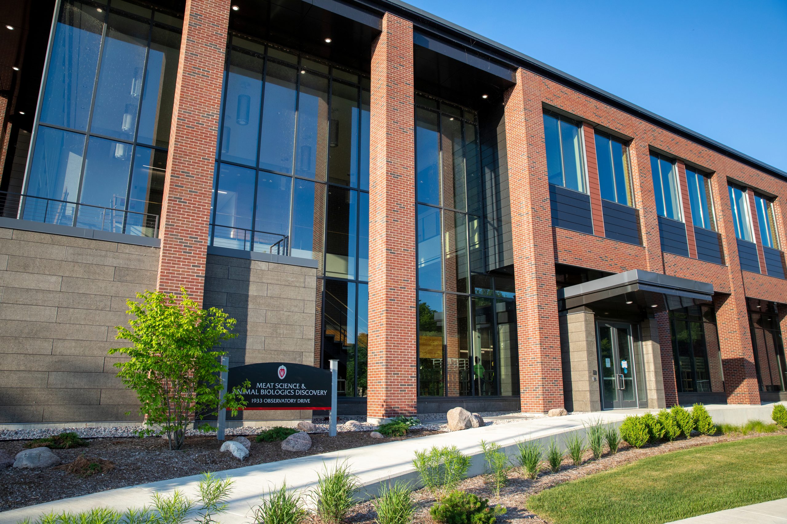 The outside of the MSABD Building features brown brick, black metal trim, and large glass windows. Between two and three stories, the MSABD Building is squarish and evokes a butcher's block.