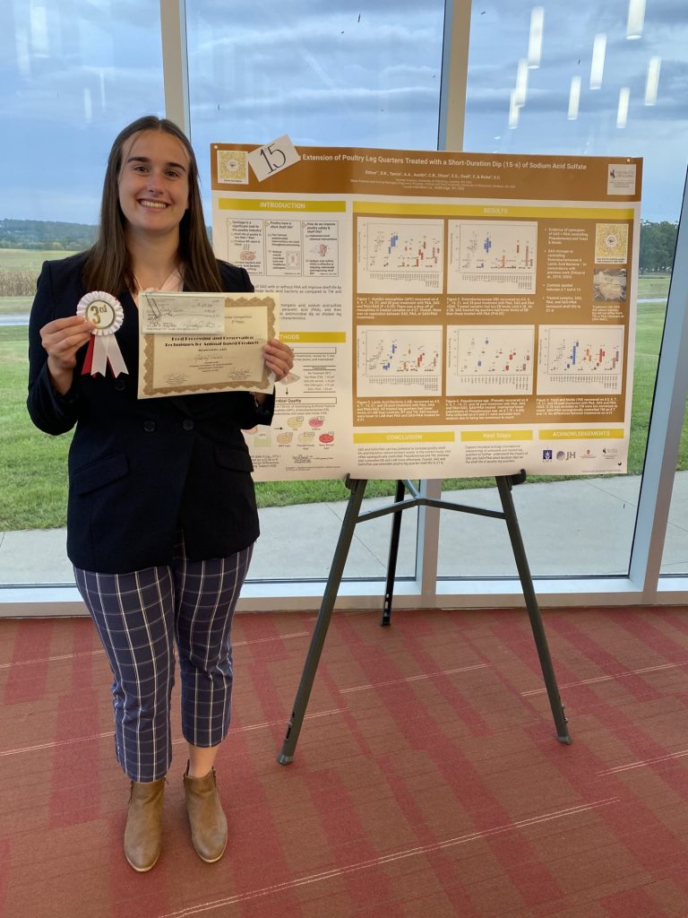 Ashley Tarcin with one of her posters at AAFP.